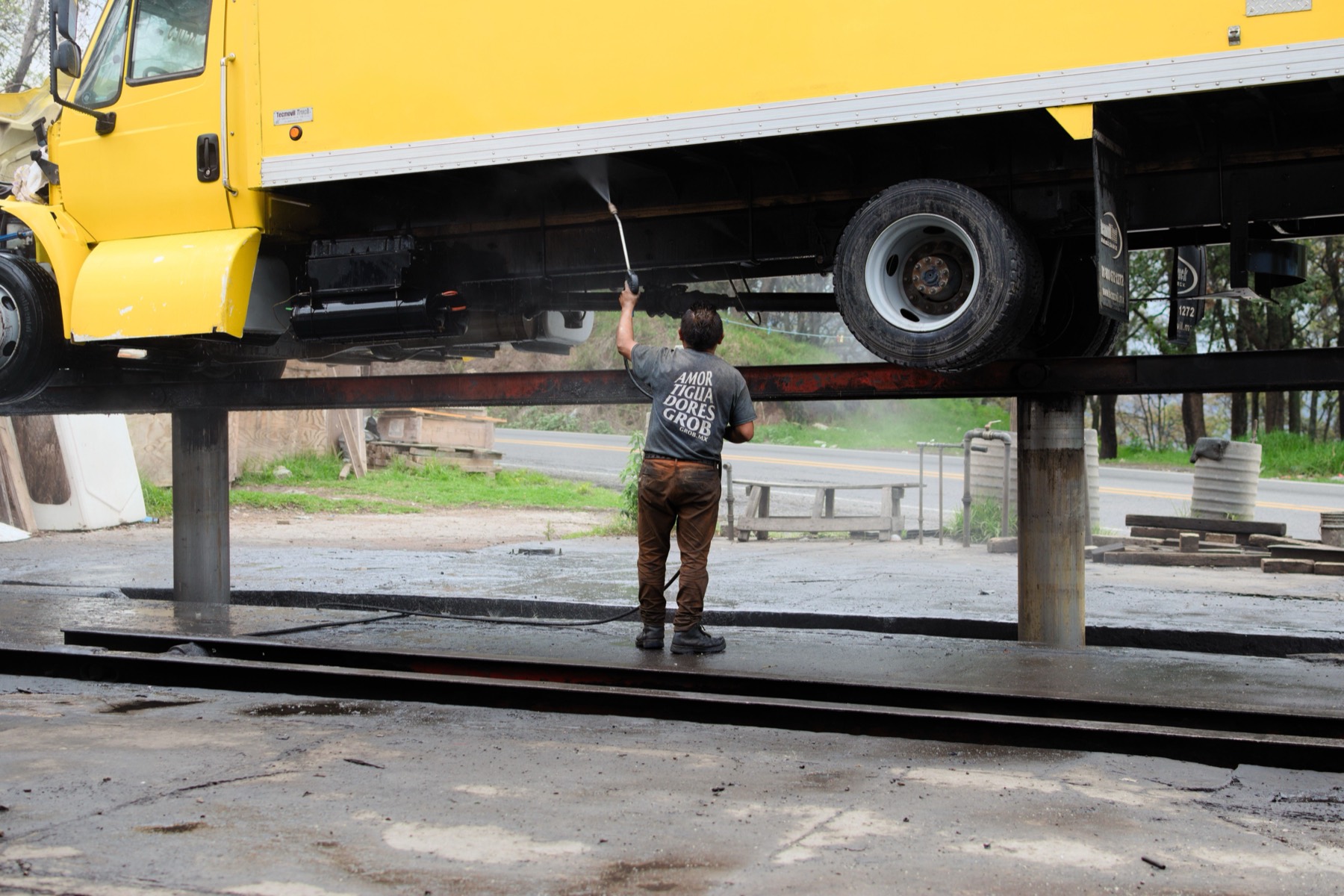 Heavy vehicle up on the ramp being washed down