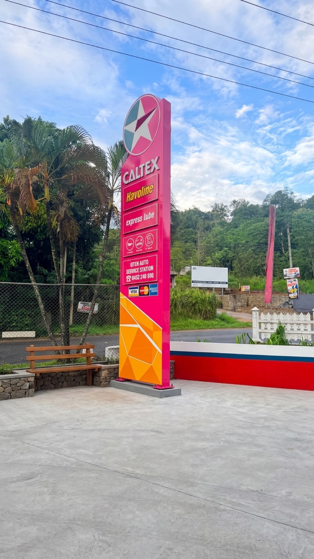 The OTEK Auto Service Station sign at the roadside